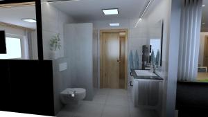 a bathroom with a toilet and a sink at Gästehaus Oberauer in Annaberg im Lammertal +21 photos