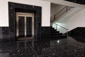 a building with a staircase and a door with a tile floor at Hotel Bhavishyaa Vrindavan in Vrindāvan
