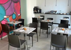 a restaurant with tables and chairs with food on them at Boutique Hotel Magenta in Magenta