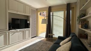 a living room with a couch and a tv at Blue Roof in Fidenza