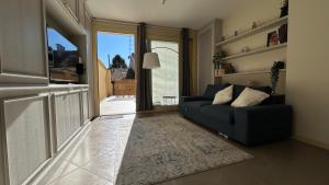 a living room with a couch and a large window at Blue Roof in Fidenza