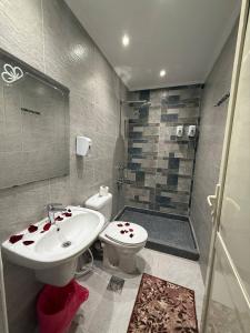 a bathroom with a sink and a toilet and a shower at Golden Palace Suites in Cairo +63 photos
