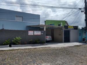 a house with a car parked in front of it at Casa Wense - prox a praia in Ilhéus