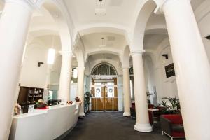 a view of the lobby of a building with columns at Lázeňský Hotel Sadový Pramen in Karlovy Vary