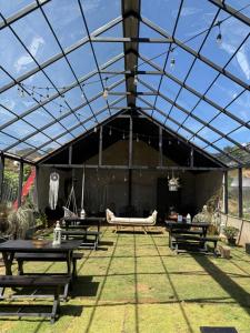 a large tent with tables and a hammock under it at Blackpool Farm House in Nuwara Eliya