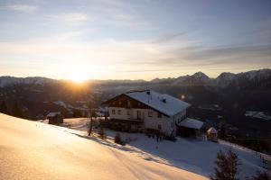 a house on top of a snow covered mountain at Hecherhaus in Schwaz