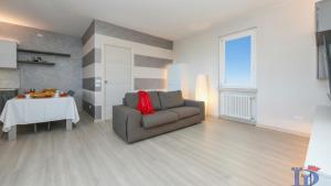 a living room with a couch and a table at H2o Green Residence with 3 pools DesenzanoLoft Official Partner Homes & Villas by Marriott Bonvoy in Desenzano del Garda