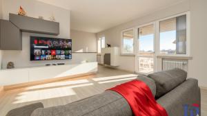 a living room with a couch and a tv at H2o Green Residence with 3 pools DesenzanoLoft Official Partner Homes & Villas by Marriott Bonvoy in Desenzano del Garda