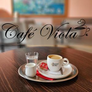 a plate with two cups of coffee on a table at Lázeňský Hotel Sadový Pramen in Karlovy Vary +13 photos