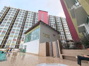 a building in front of a large apartment building at AZ Mahkota Valley Suites studio in Kuantan