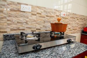 a kitchen with a stove top on a counter at Arusha Oasis Executive Residence in Arusha