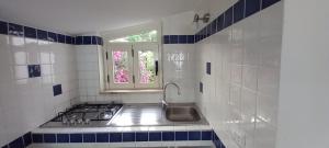 a kitchen with a stove and a sink and a window at Terrazza sul Mare Case Vacanze in Capo Rizzuto +71 photos