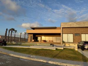 a house with a car parked in front of it at Casa riviera in Aquiraz