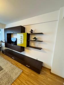 a living room with a tv on a wall at Class Belvedere Apartments in Oradea