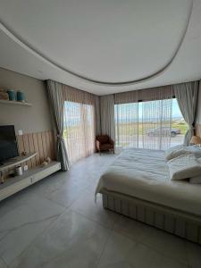 a large bedroom with a large bed and a tv at Casa riviera in Aquiraz +29 photos
