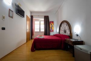 a bedroom with a red bed and a window at B&B Il Sedile in Lecce