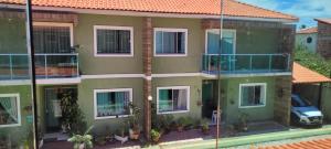an apartment building with a car parked in front of it at LardoceLar in Camaçari