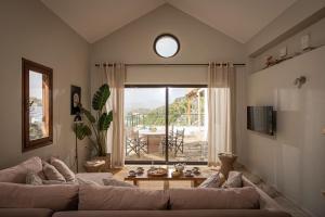 a living room with a couch and a large window at Istron Luxury Villas in Istro