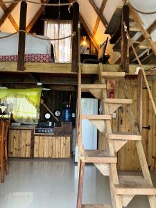 a room with a bunk bed and a ladder at Canada House Queen bed in 2nd floor dbl sofa bed in 1st floor BBQ Private pool, river in Jarabacoa