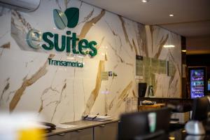 an office wall with a sign for autes tasmania at Esuites Sorocaba in Sorocaba