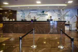 a lobby with two people on their laptops at a counter at Esuites Sorocaba in Sorocaba +79 photos