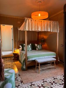 a bedroom with a bed and a canopy bed at Casa Con Destino in Jalón