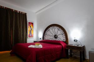 a bedroom with a large bed with a red blanket at B&B Il Sedile in Lecce +9 photos