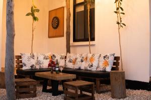 a living room with a couch and a table at Kena Beach Villas in Marumbi