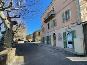 a street in a town with a building at Gite rustique de charme chez Santa é Pasquà in San-Martino-di-Lota