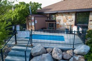 a swimming pool in front of a house with rocks at Sigi's Longhorn Lodge WL1409 Gym Ski Powder Mtn in Eden