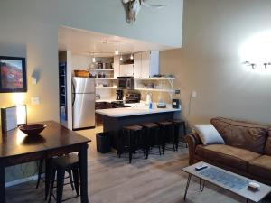 a kitchen and living room with a couch and a table at Sigi's Longhorn Lodge WL1409 Gym Ski Powder Mtn in Eden +60 photos