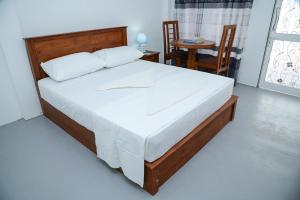 a bedroom with a bed and a table and chairs at Amila Resort - Habarana in Habarana +84 photos