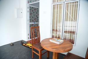 a table and a chair with a book on it at Amila Resort - Habarana in Habarana