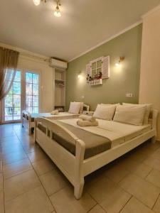 a large bedroom with two beds and a window at Orea Boutique Studios in Asprovalta