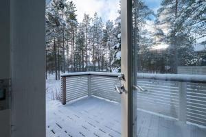 an open door to a patio with snow on it at Villa Luoto A Stylish semi-detached house Incl AC, Sauna, Terrace in Kalajoki