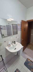 a bathroom with a sink and a toilet and a mirror at Stella Marina Bed and Breakfast sul mare in Realmonte +29 photos