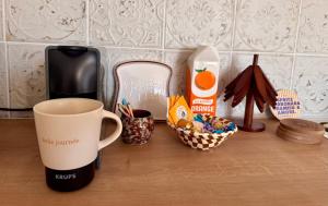 a coffee cup sitting on a counter with a cup of coffee at La Romance in Acy-Romance +4 photos