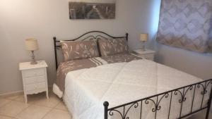 a bedroom with a large bed with two night stands at Stella Marina Bed and Breakfast sul mare in Realmonte