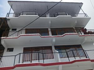 a balcony of a building with people on it at Amazing view Home Stay in McLeod Ganj +28 photos