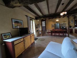 a living room with a kitchen and a dining room at La Mérais in Marsac-sur-Don