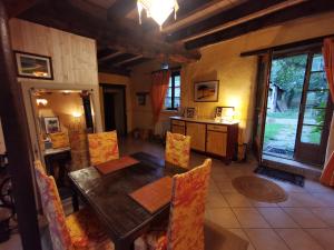 a dining room with a wooden table and chairs at La Mérais in Marsac-sur-Don