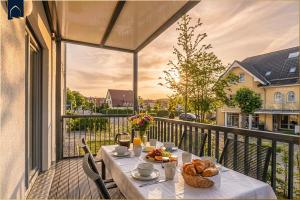 a table with food on top of a balcony at Ostseebude in Loddin