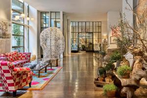 a living room with a couch and a table at Crosby Street Hotel in New York