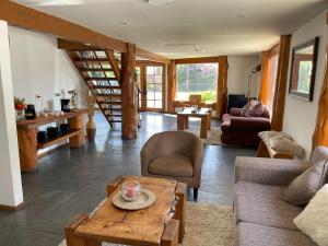 a living room with a couch and a table at Hotel Kernayel in Pucón