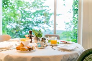a table with breakfast food on it with a window at Hotel Palacio Urgoiti in Mungia