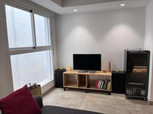 a living room with a flat screen tv on a table at Centro Histórico - Beneficencia Flat in Valencia
