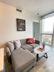 a living room with a couch and a table at Pine Breeze in Markham