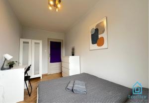 a bedroom with a bed and a desk and a picture at Funky Room - 5 Minutes to Sopot Molo & Seaside in Sopot