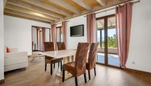 a dining room with a table and chairs and a tv at Finca Binibona Parc Natural in Binibona +53 photos