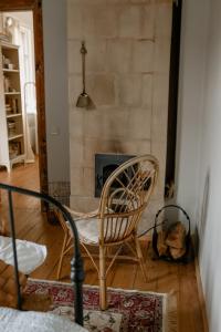 a room with a chair and a fireplace at Vēsturiska privātmāja Ogres centrā in Ogre